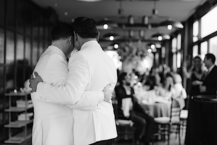 Ron and Mark embracing at their wedding reception, NYC