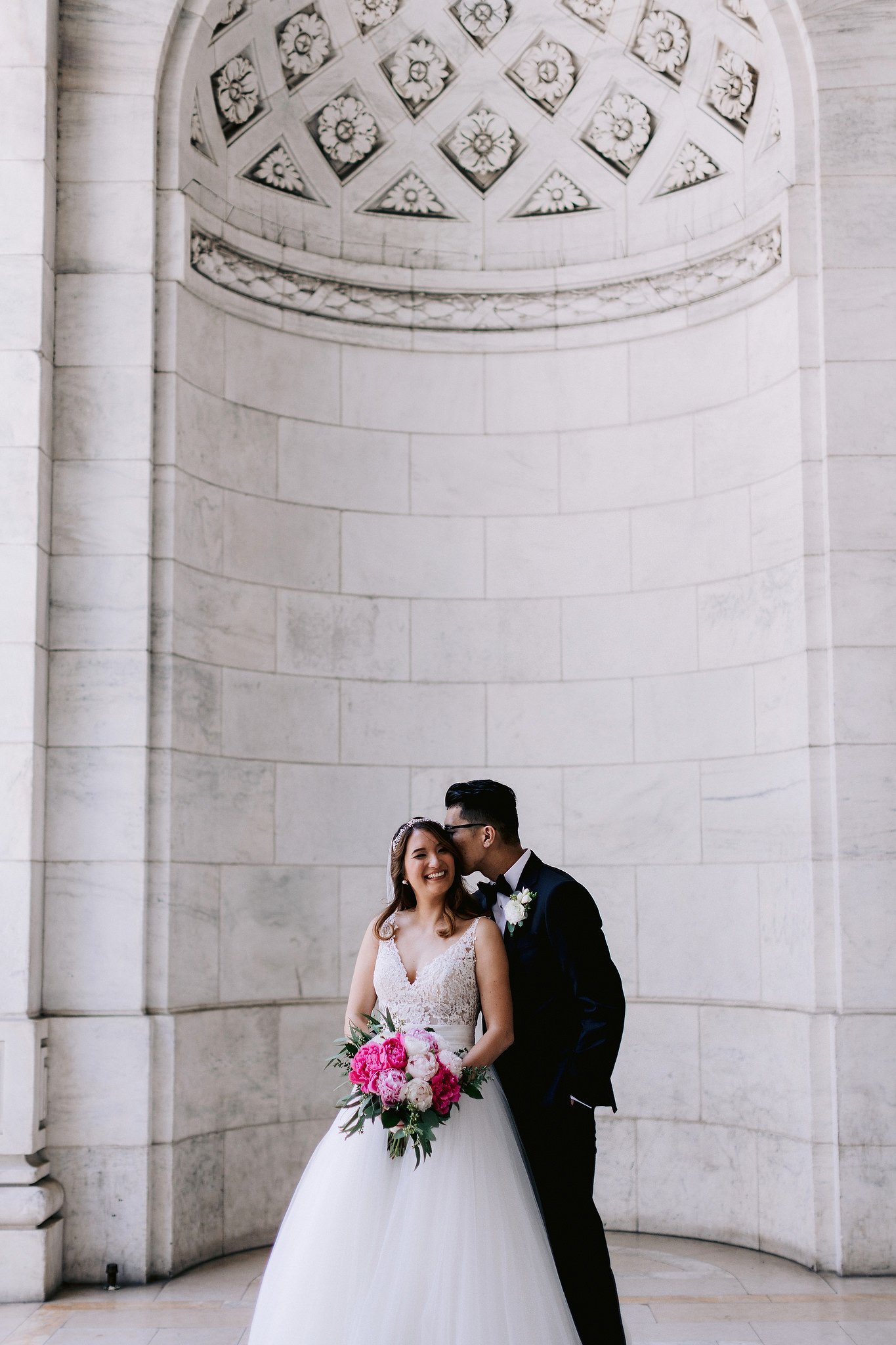 Groom kisses his future wife on the cheek