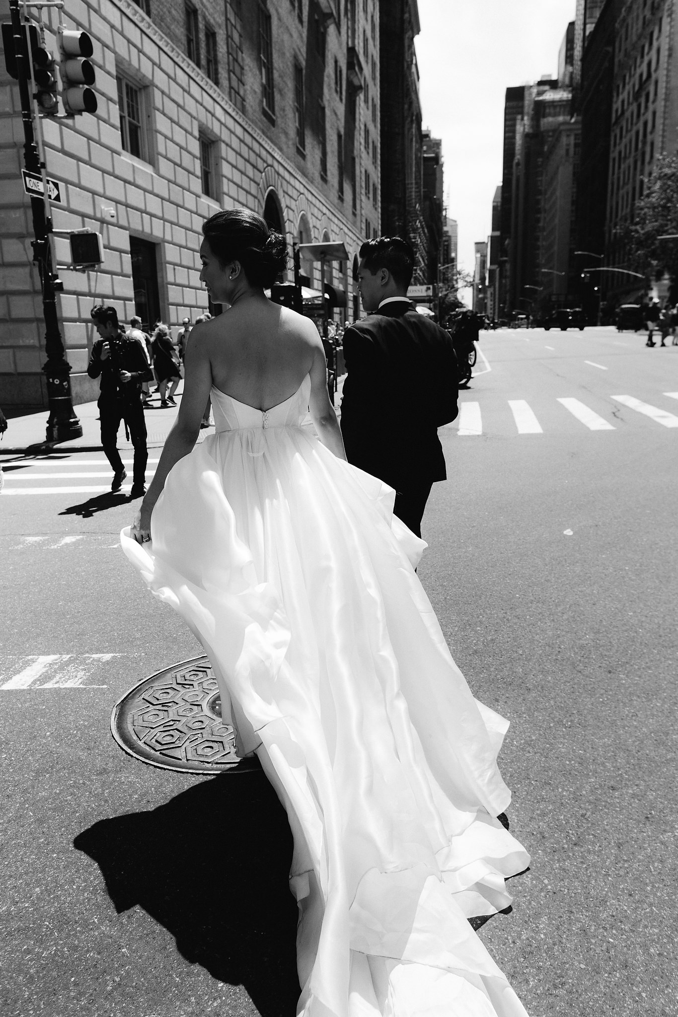 A bride fans our the train of her wedding gown