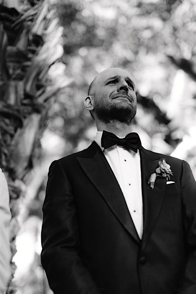 Groom tearing up when seeing his bride walk down the aisle.