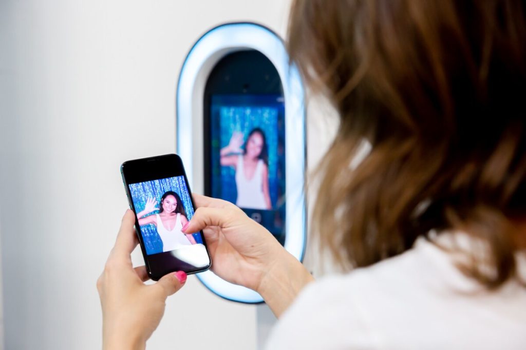 Woman downloading her picture from a Photo Booth.