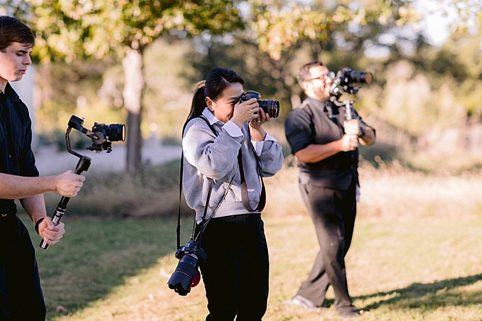 wedding photographer taking a photo outdoors