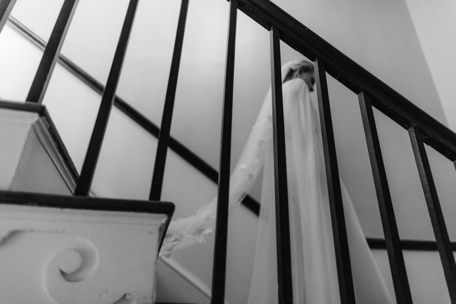 bride walking down stairs, first look