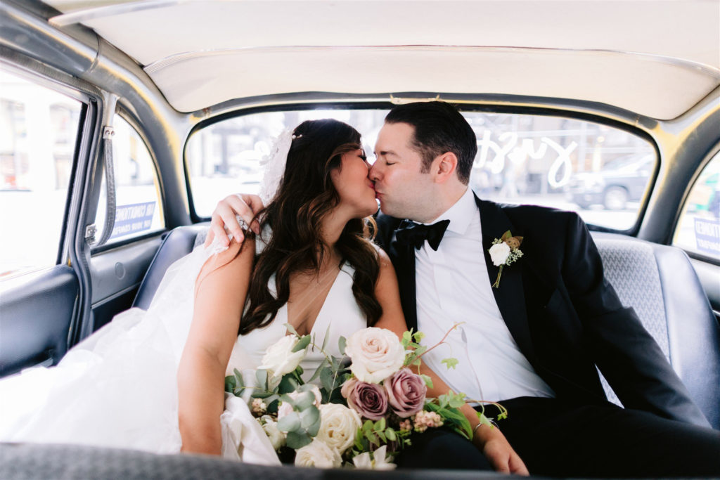 st. patricks cathedral, jw marriott essex house, bridal, wedding, groom, bride, classic new york wedding, bride and groom share a kiss inside a vintage taxi, film cars New York, checker cab, Manhattan wedding