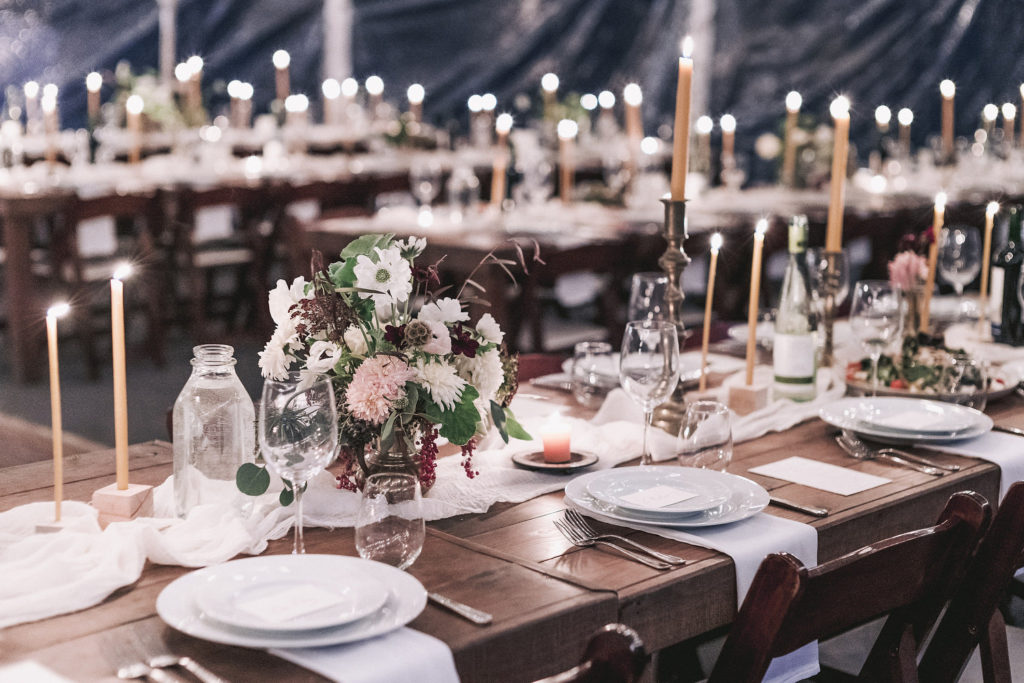 reception dinner hall set up with muted tones of flowers and candles everywhere. Editorial Wedding at Firefox Mountain House in Upstate New York.