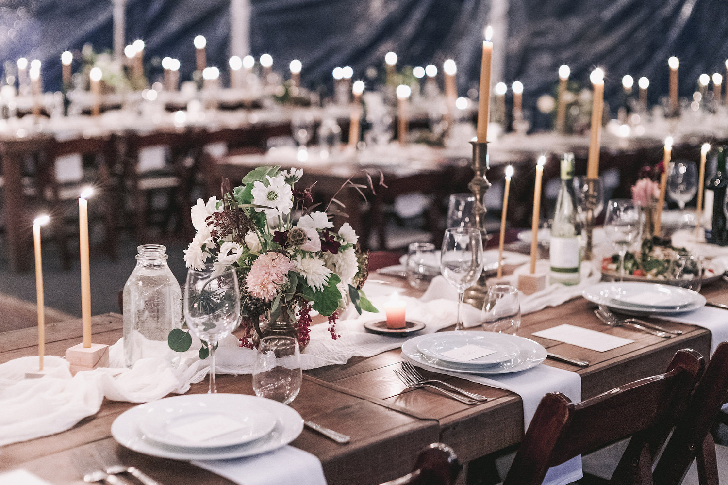 reception dinner hall set up with muted tones of flowers and candles everywhere. Editorial Wedding at Firefox Mountain House in Upstate New York.