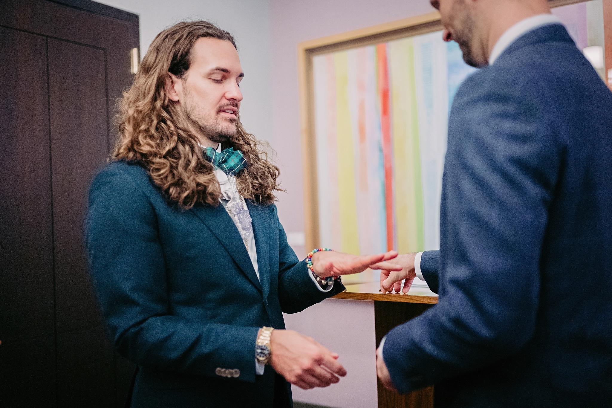 Husband and man exchanging rings