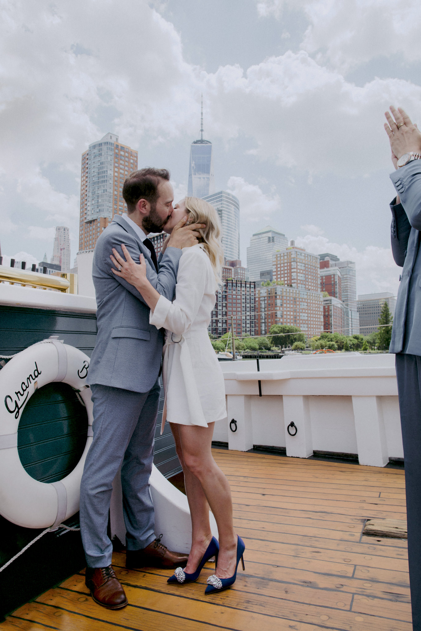 Bride and groom kissing on boat during micro wedding at Pier 25 Manhattan