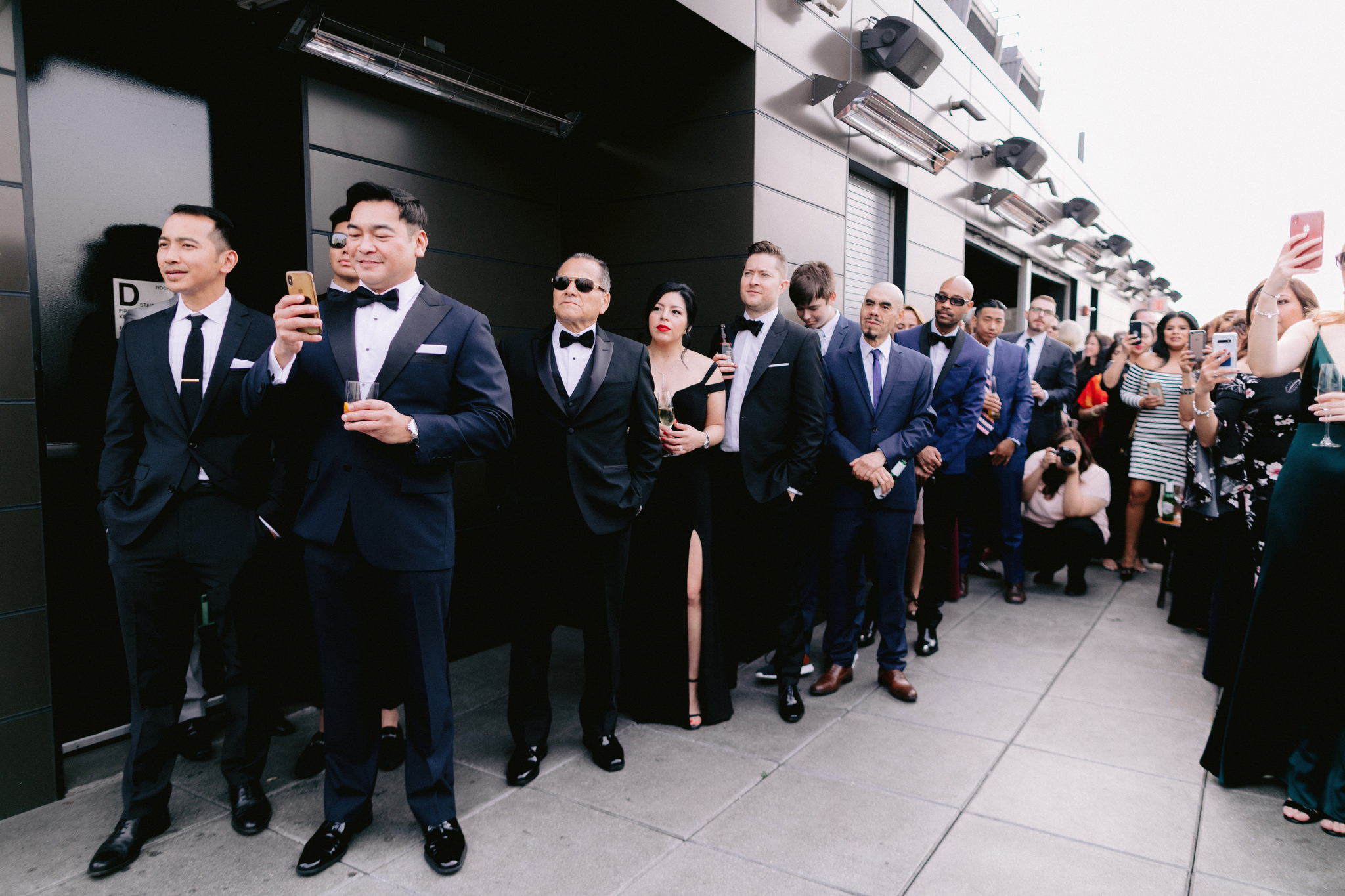 Guests smile as they watch same sex wedding ceremony at the Skylark