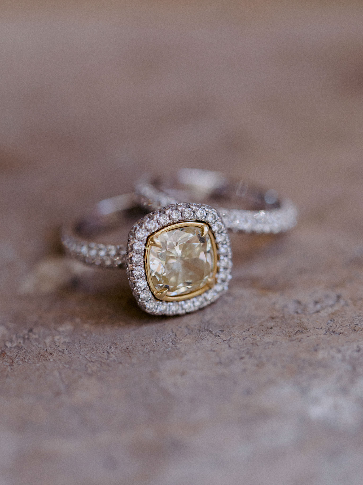 Close up view of diamond studded engagement ring and wedding band