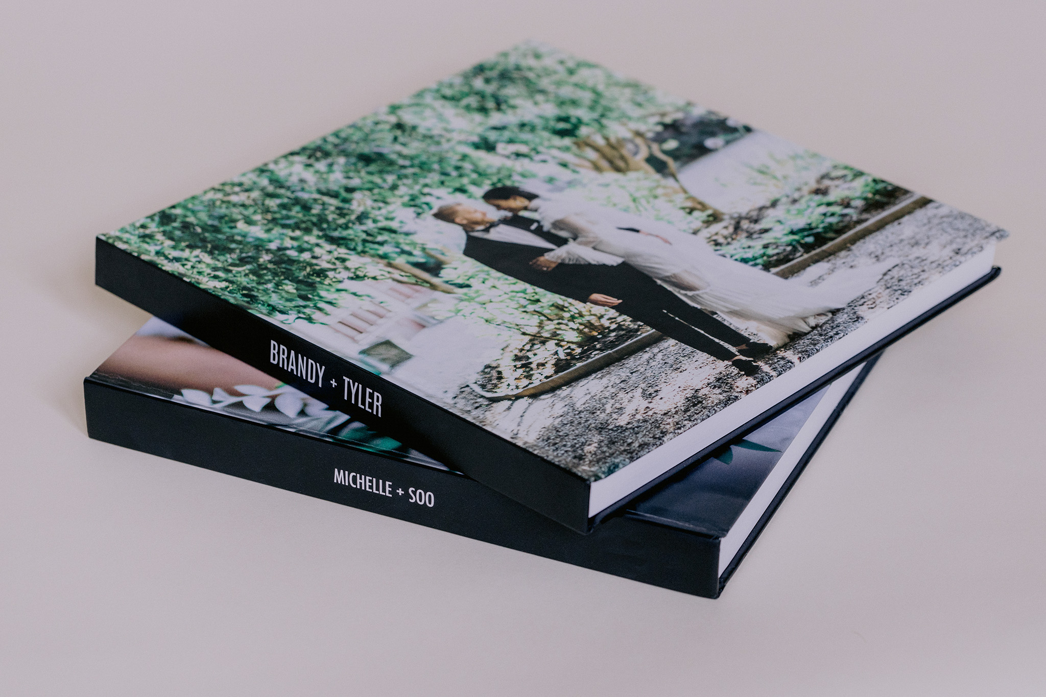 A stack of two hard cover wedding albums