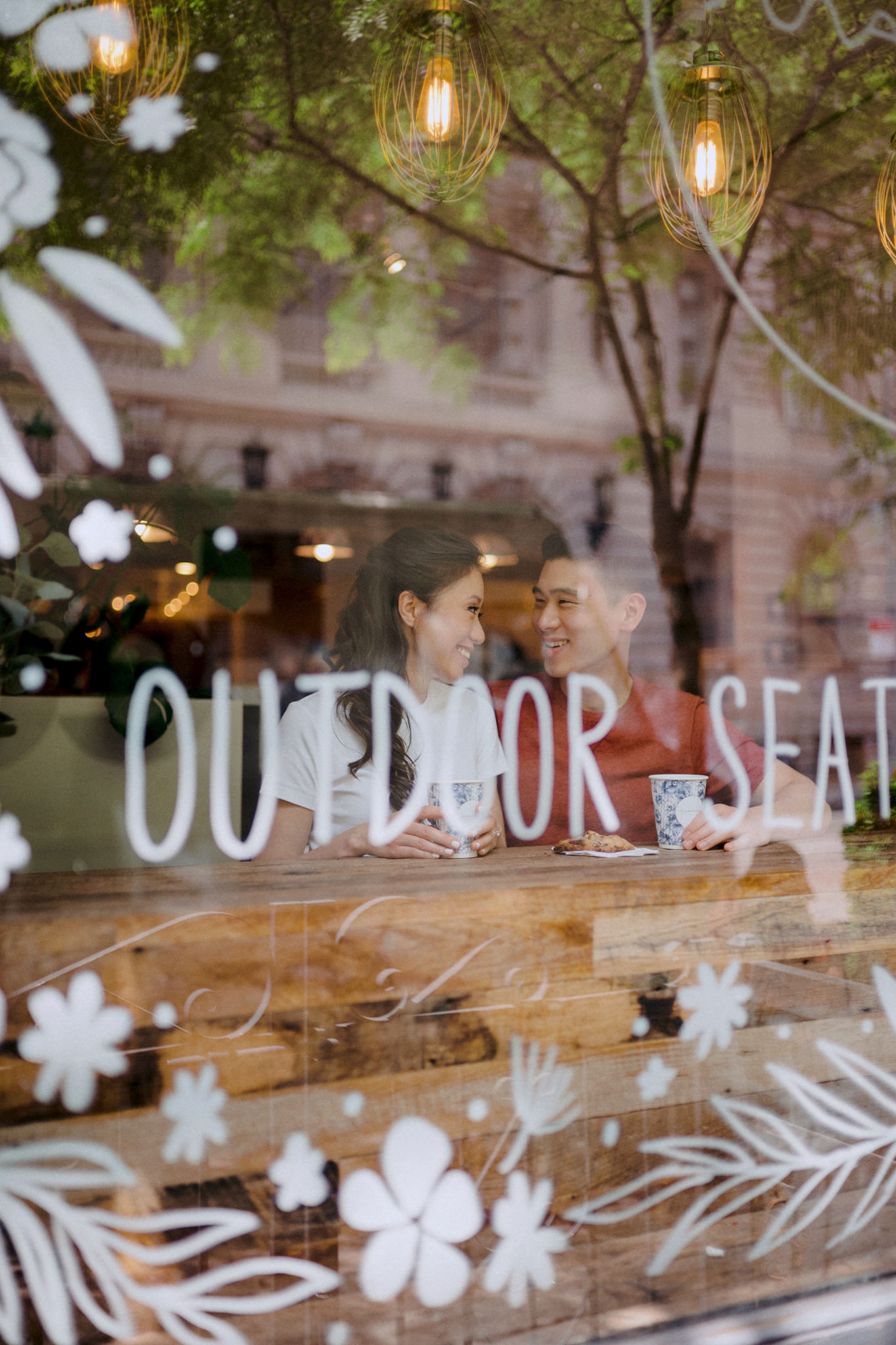 Engaged couple sitting in a cafe during an engagement session