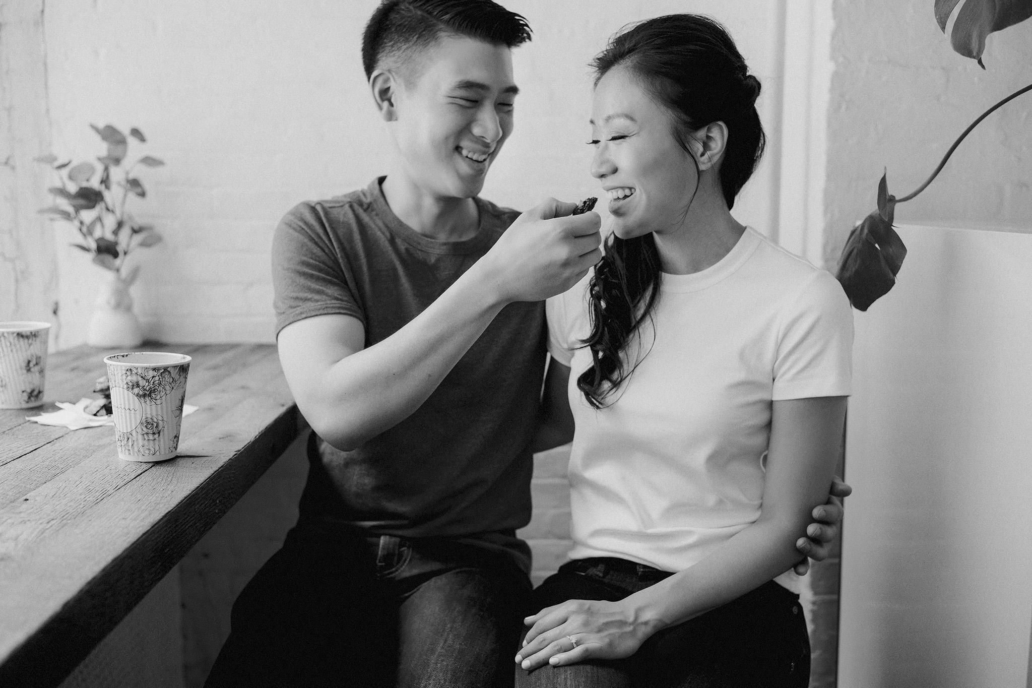 Fiance feeding his bride to be a cookie at a cafe