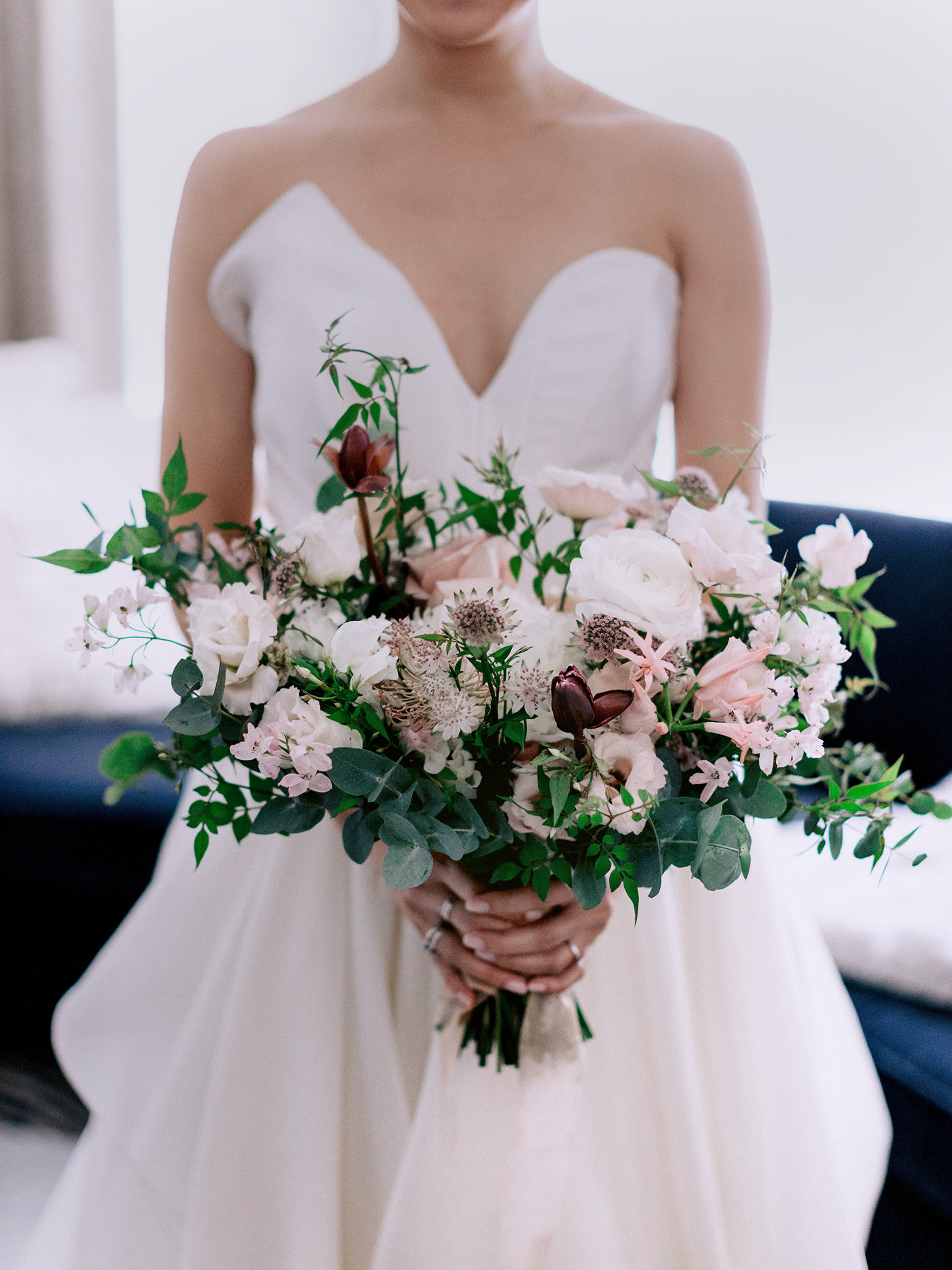 Light pink wedding flowers, held by a beautiful bride