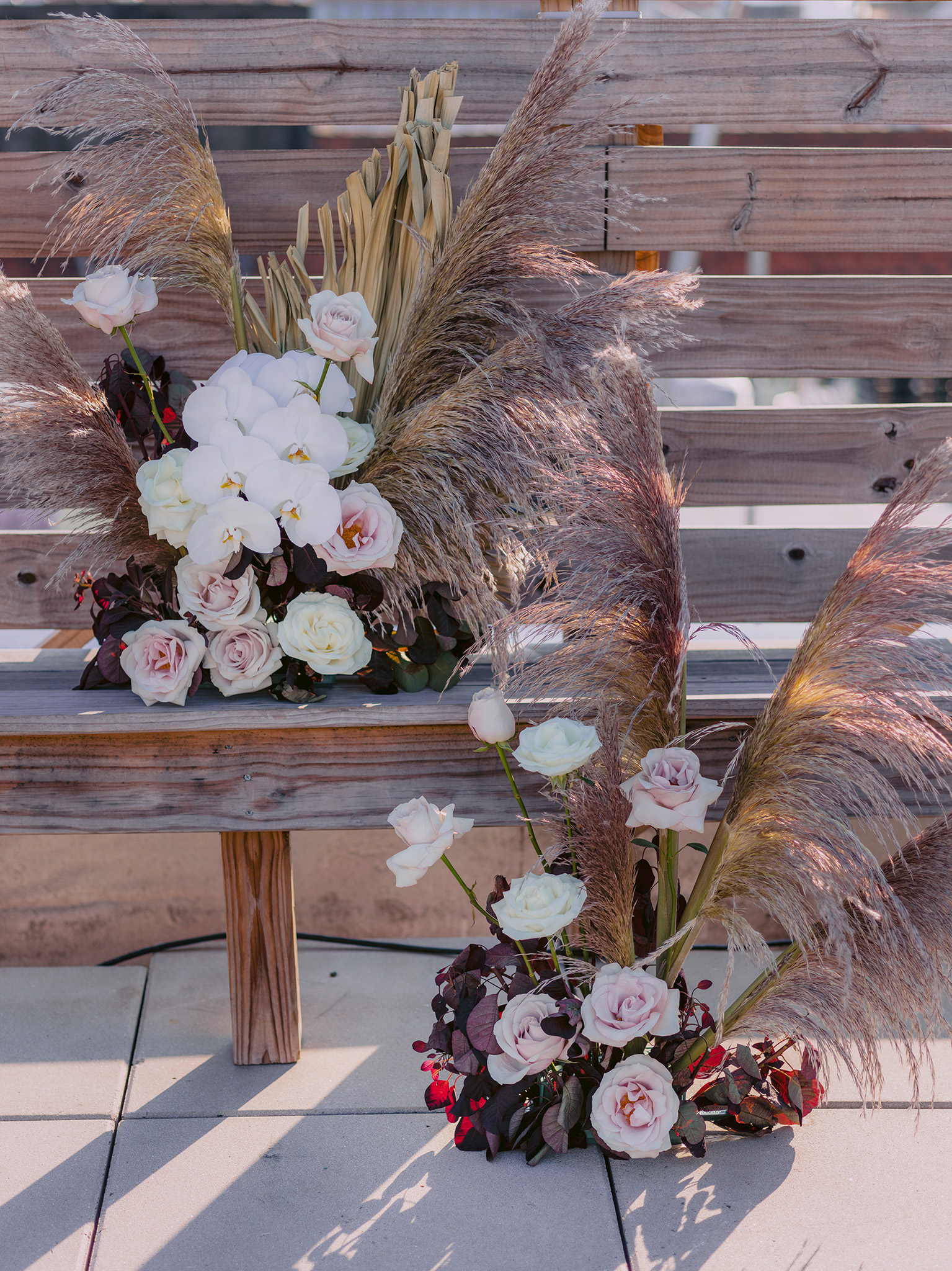 Pampas grass with roses and orchids.