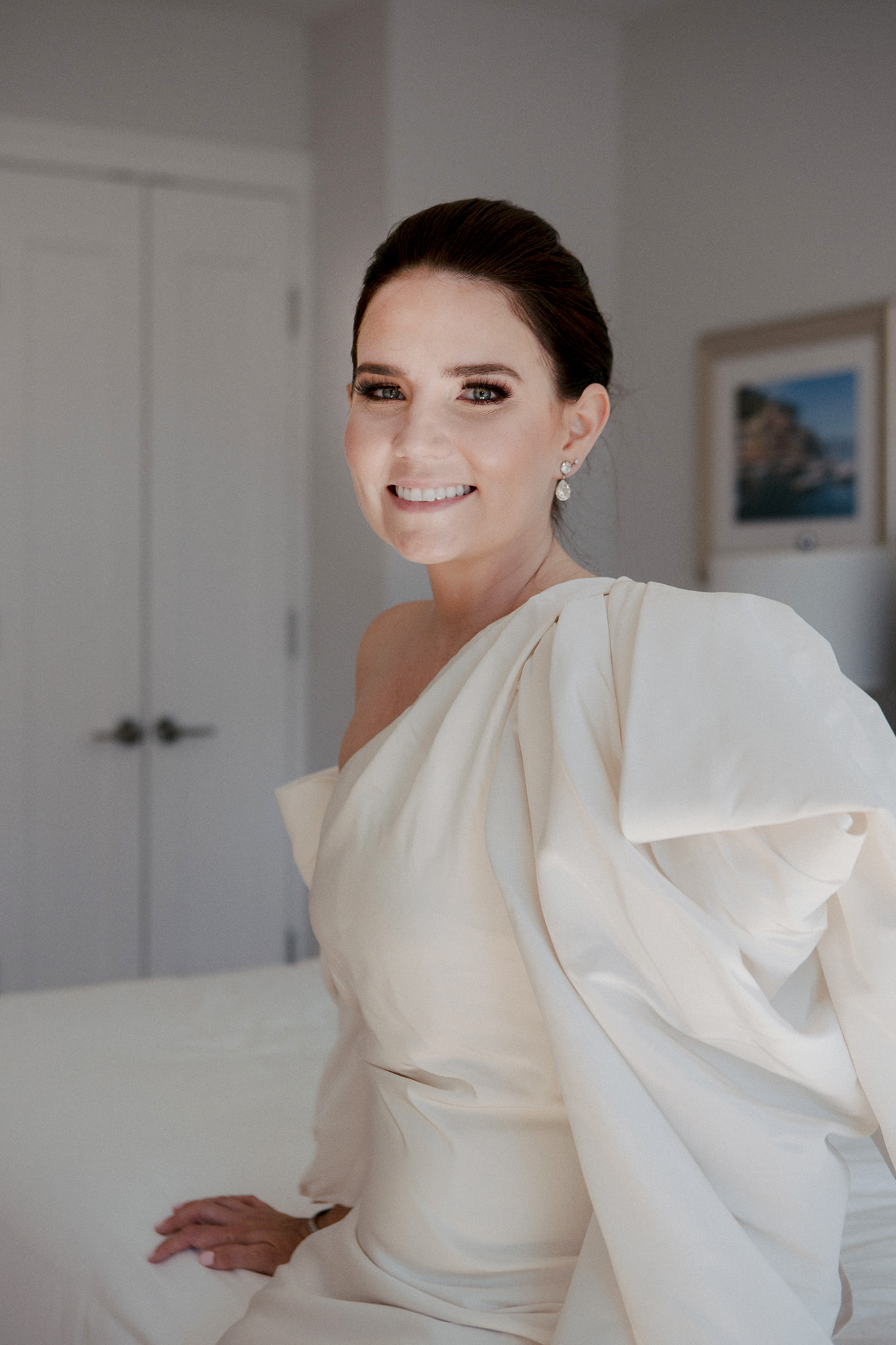 Bride to be smiling at the camera in her wedding dress