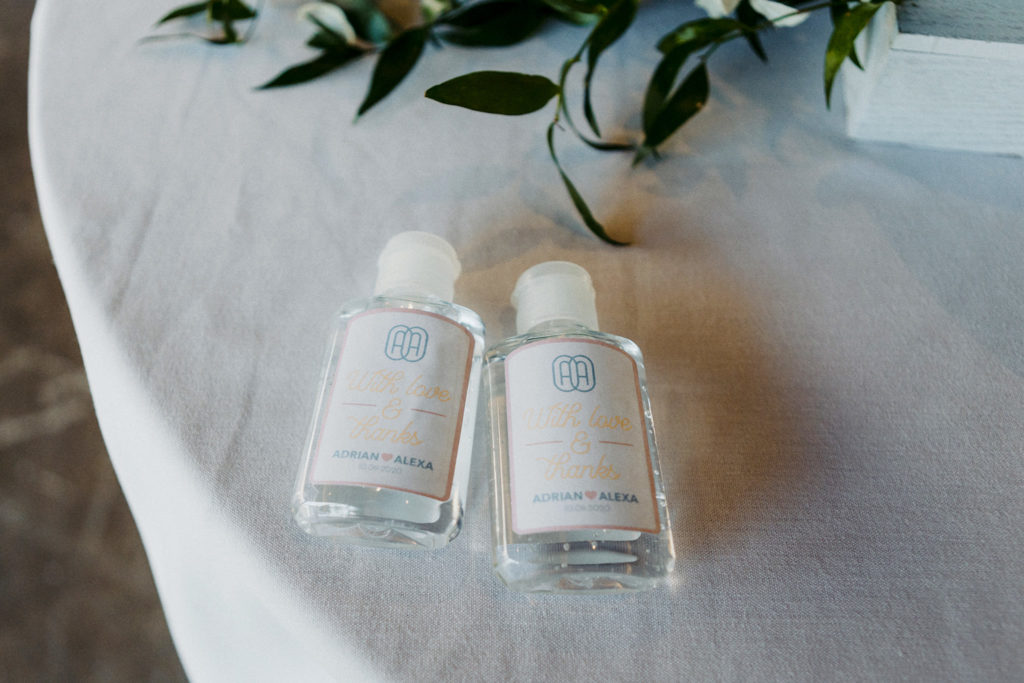 Two large hand sanitizer bottles as wedding favors for guests during COVID19 pandemic wedding.