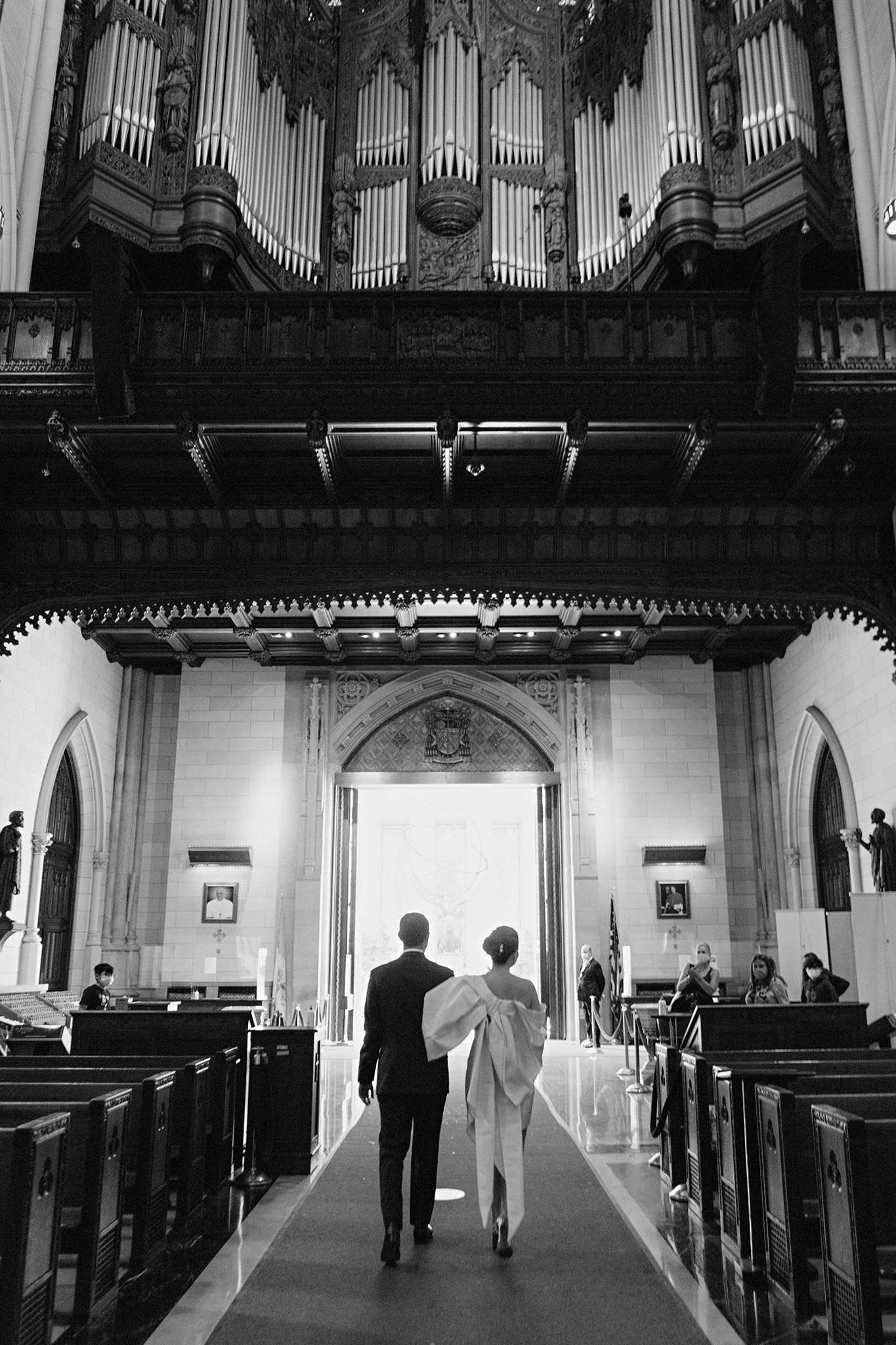 Newlyweds exiting the St. Patrick's Cathedral in New York City. bride wearing Carolina Herrera