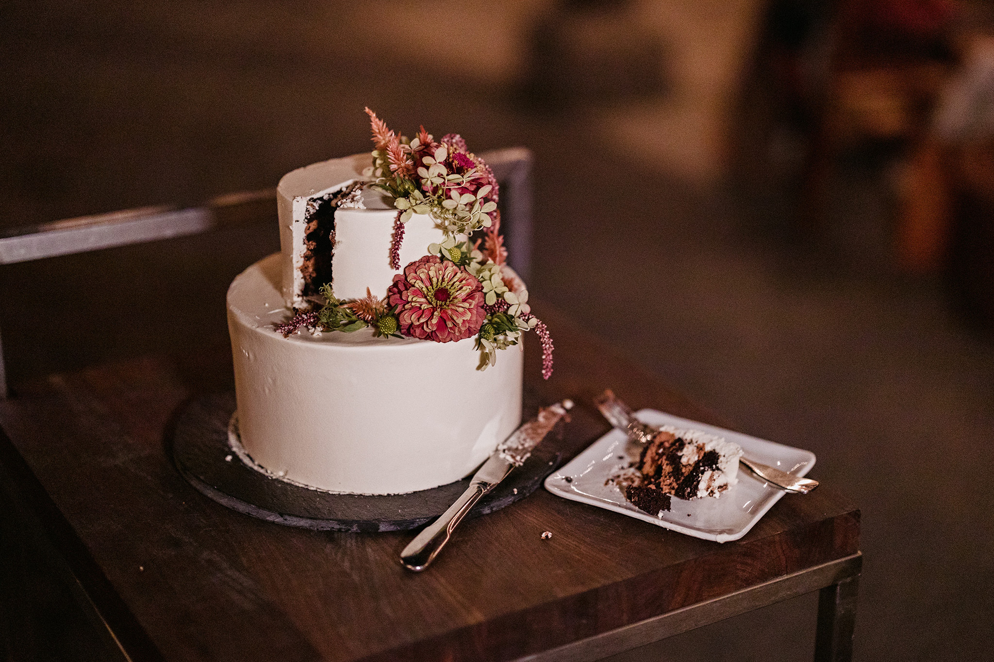 Beautiful floral wedding cake cut at Blue Hill at Stone Barns