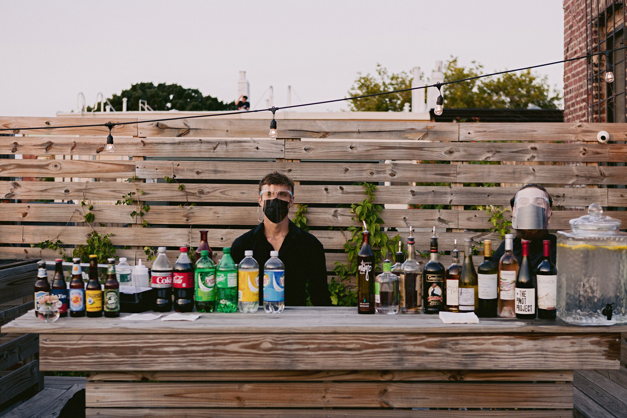 Wedding reception bartenders wearing face shields