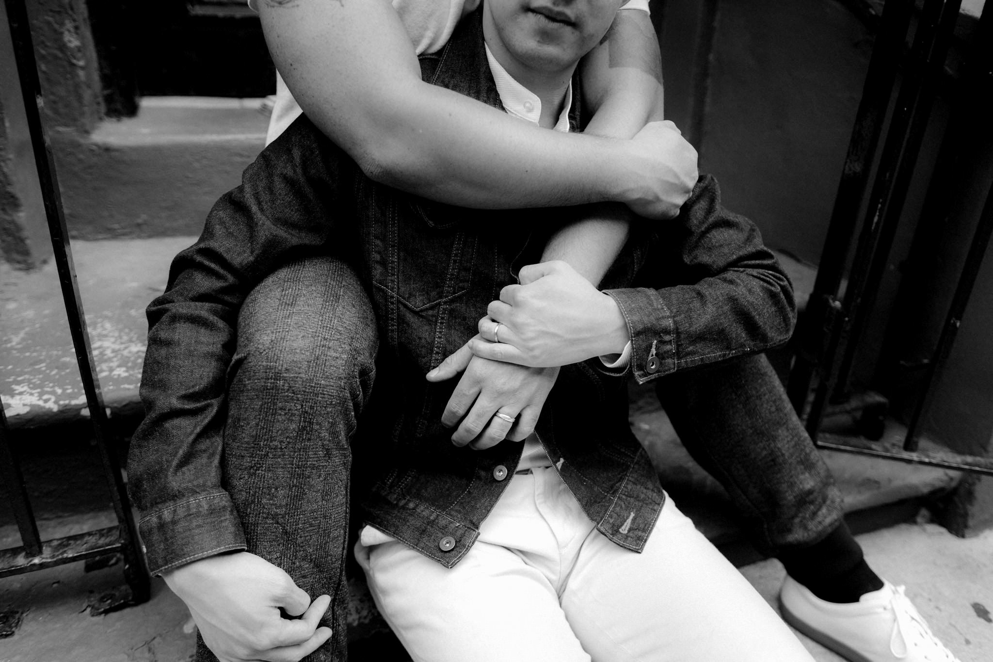 Groom and groom in New York photographing a day-after session with wedding rings