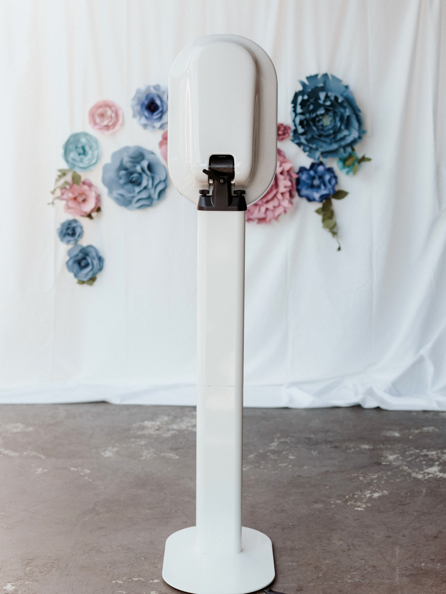 Freestanding photo booth with backdrop at a wedding reception