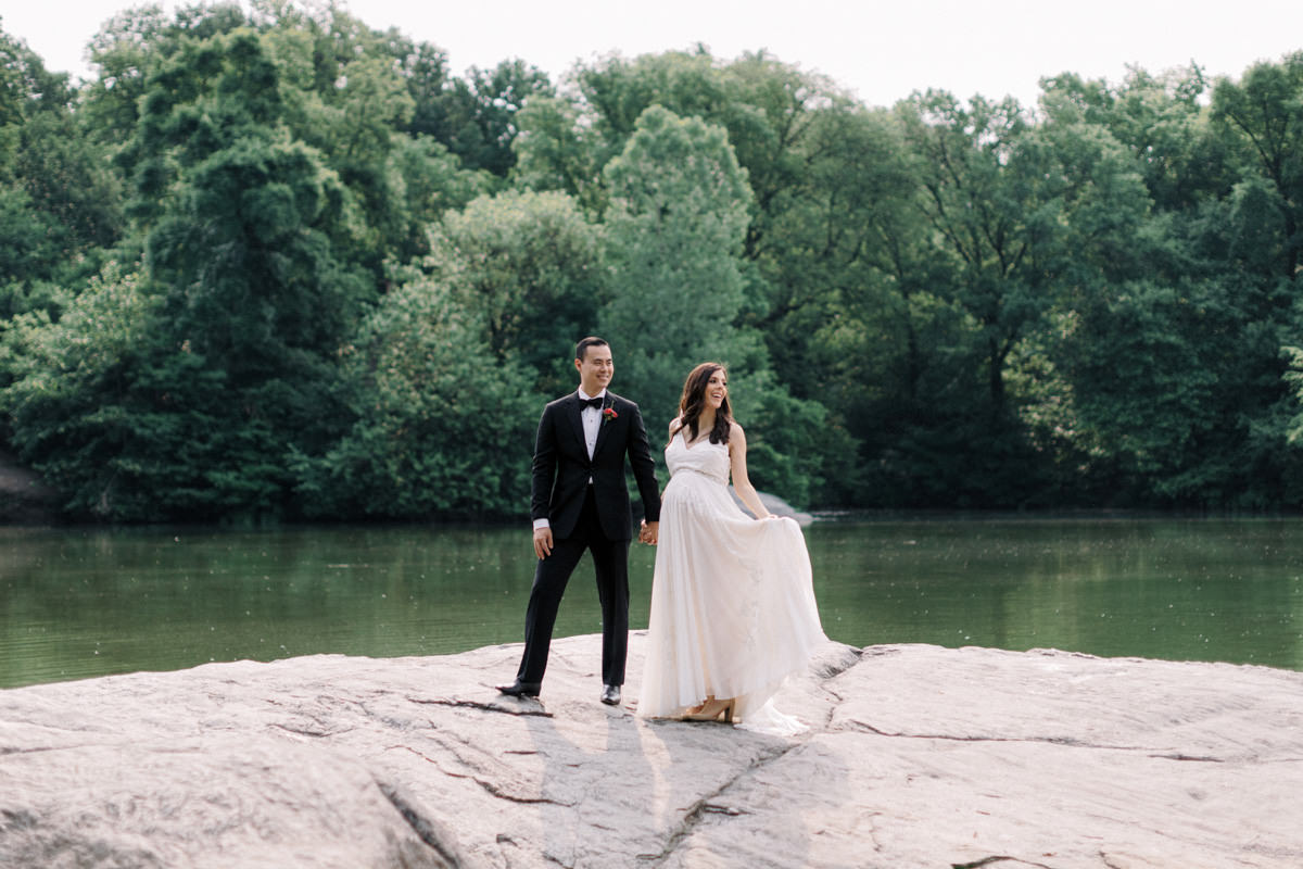 A bride fans out her wedding dress during her wedding photos