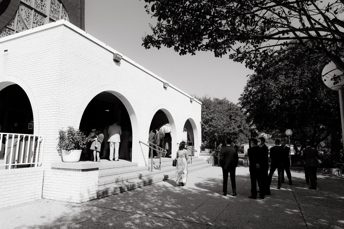 A wedding photographer takes photos of the bridal ceremony