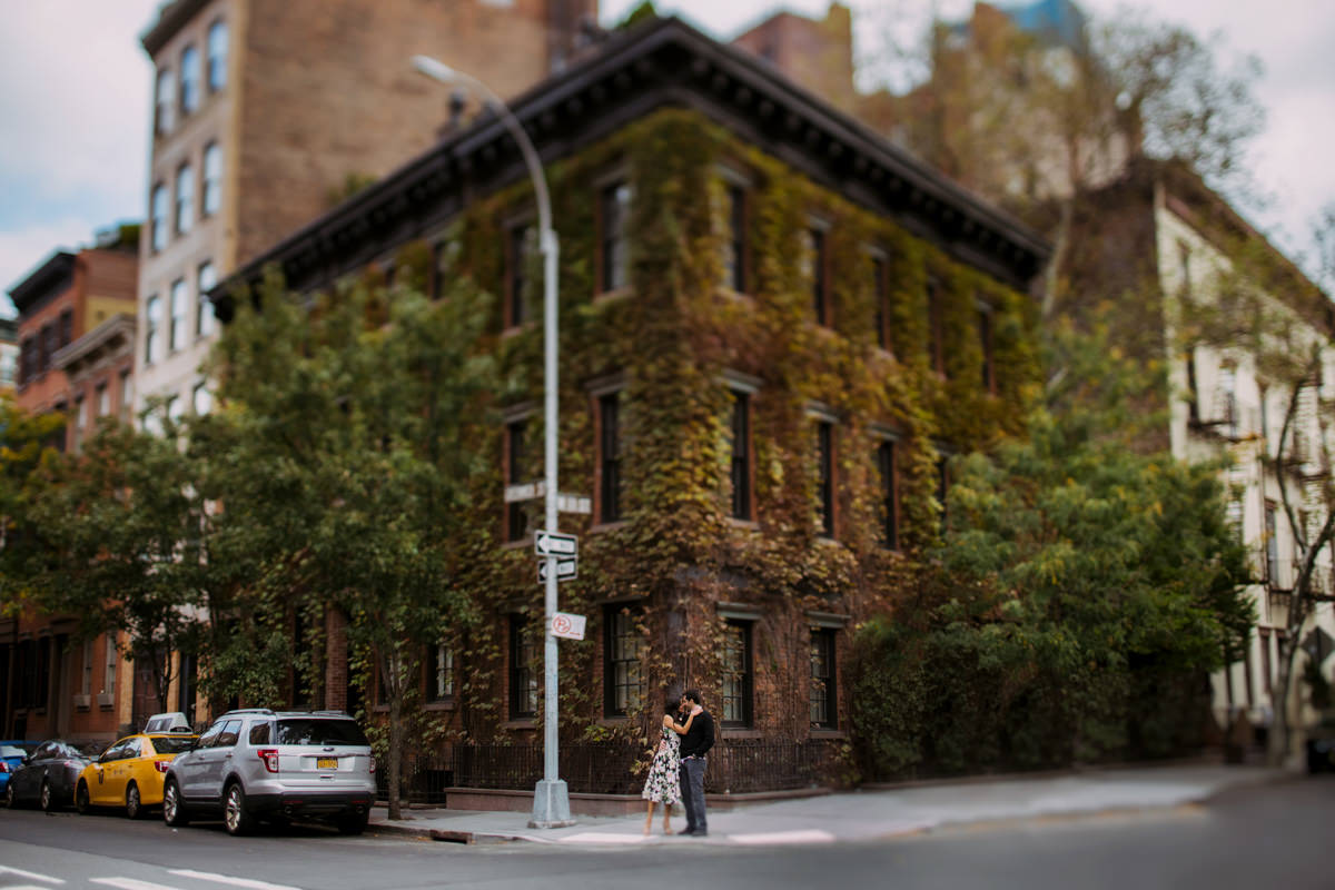 A couple kisses on the street in the West Village of NYC