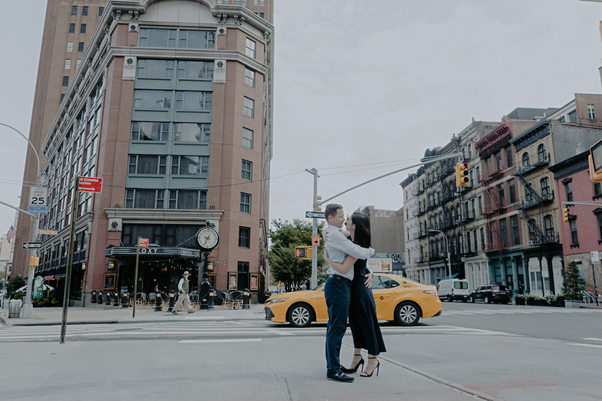 Man and woman hug in front of the Roxy hotel in the financial district of Tribeca