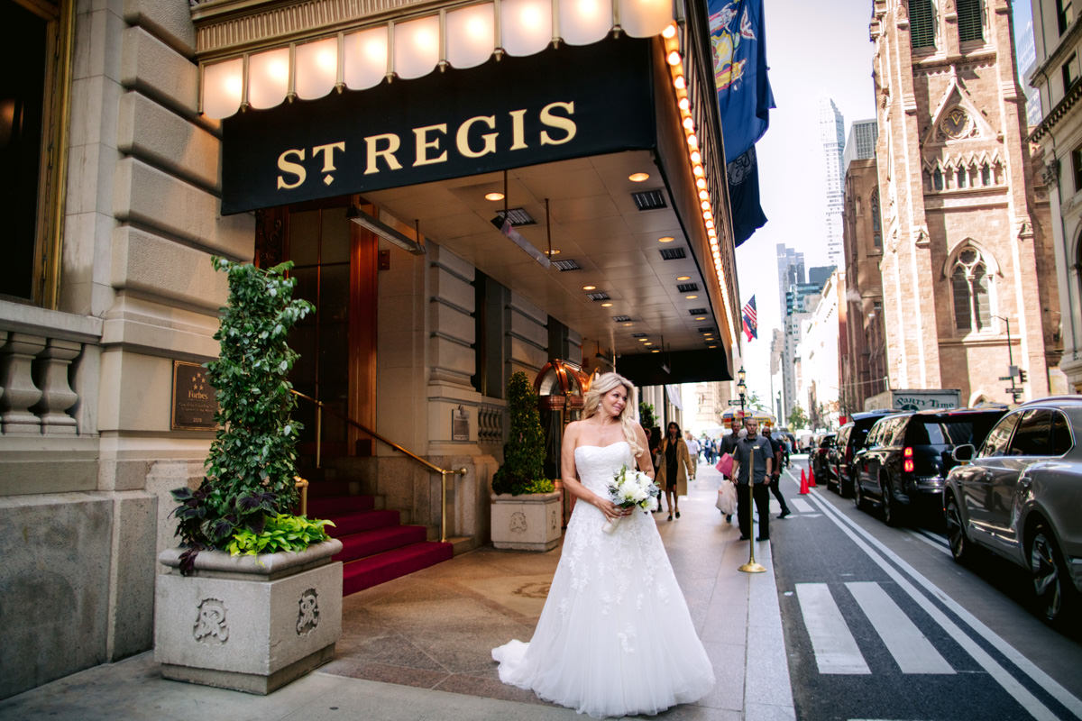 A bride posing outside of New York hotel St.Regis