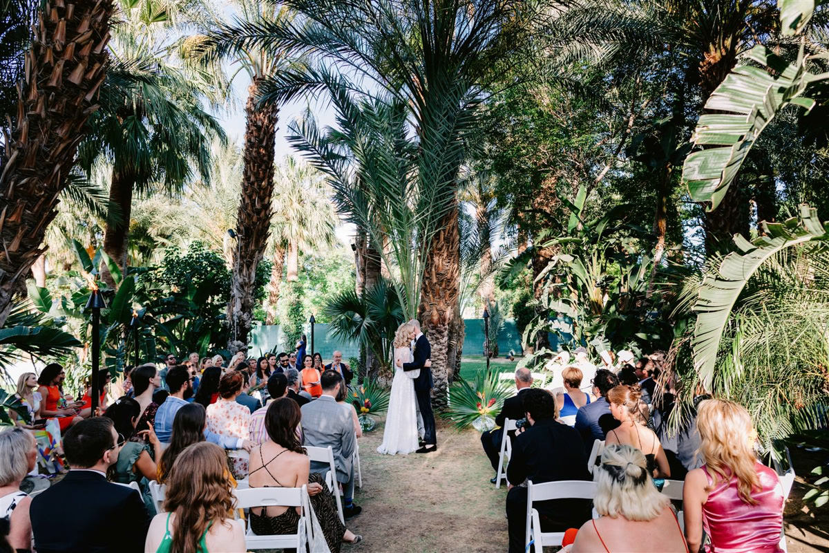 Professional wedding photographer captures a bride and grooms first kiss in Palm Springs