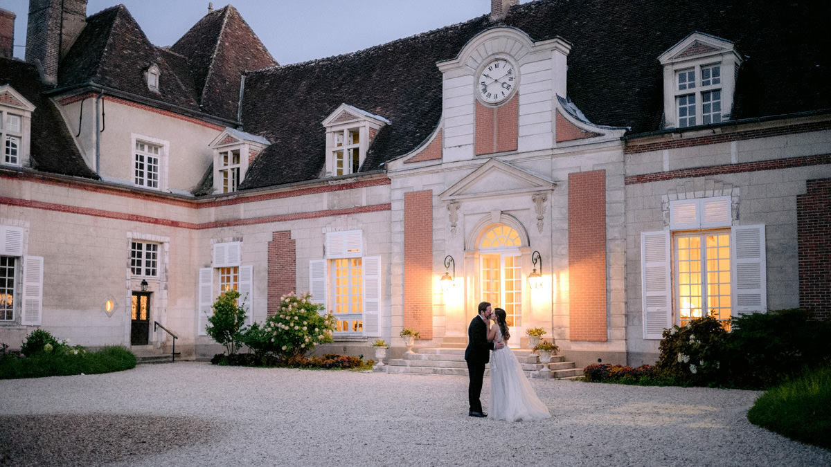 Bride and groom kiss at their destination wedding in France