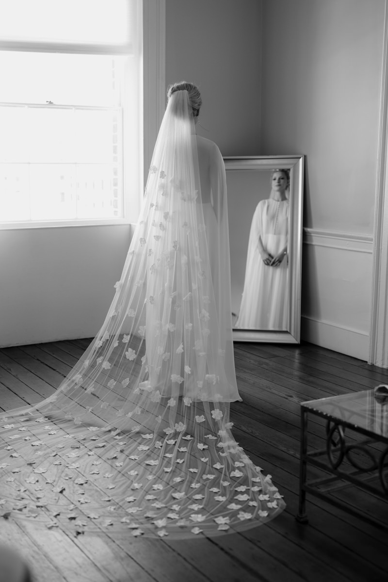 A wedding planner fans out the brides veil