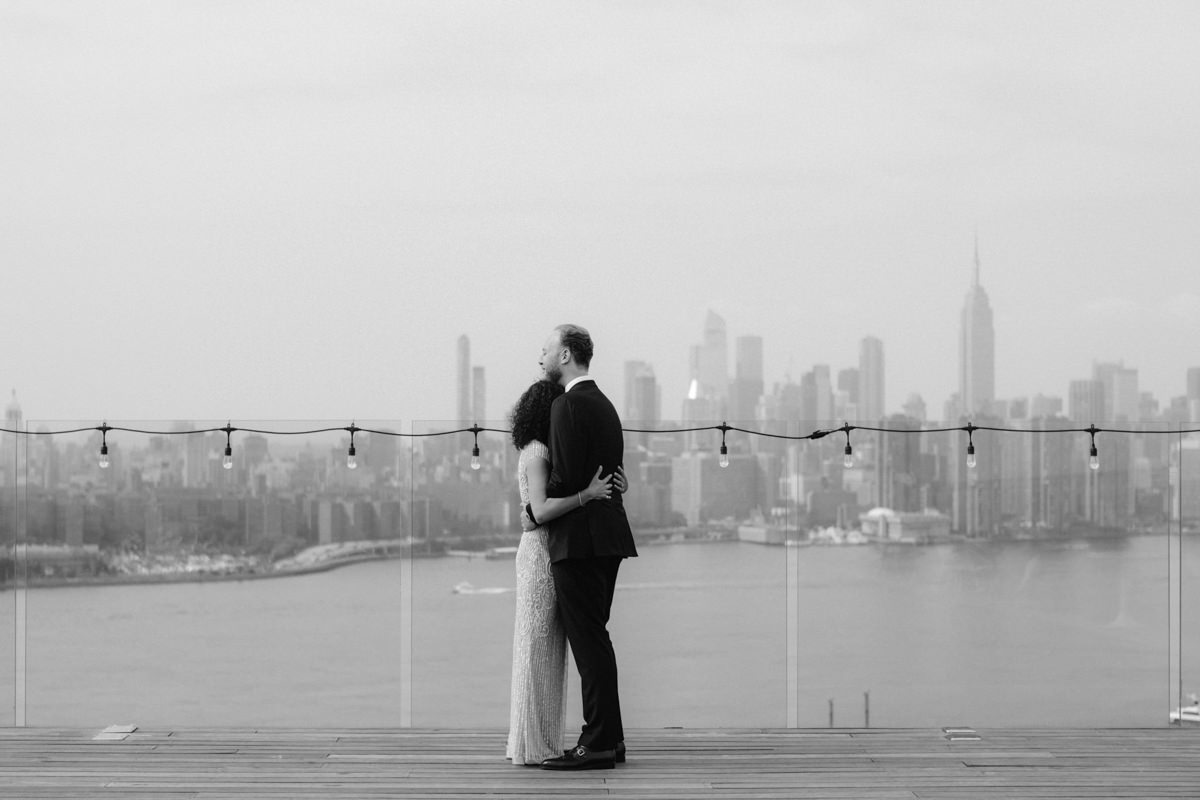 Bride and groom embrace on the rooftop of a Brooklyn Hotel