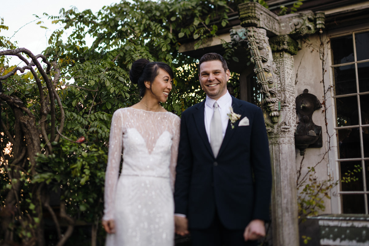 Bride and groom stand on a rooftop patio in NYC