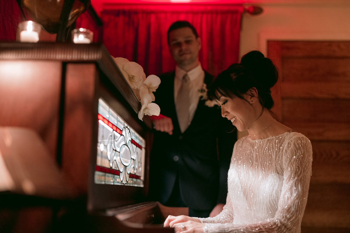 Bride in a beaded dress plays the piano