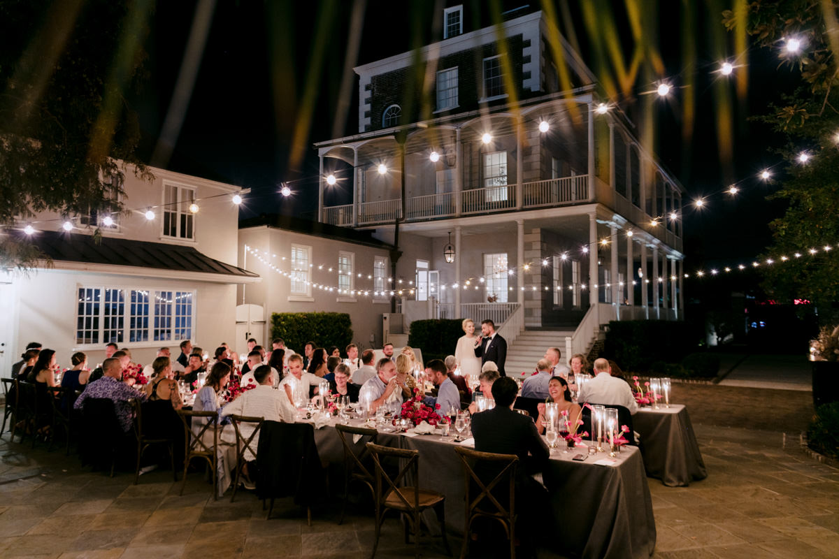 A wedding reception in the backyard of a historic building