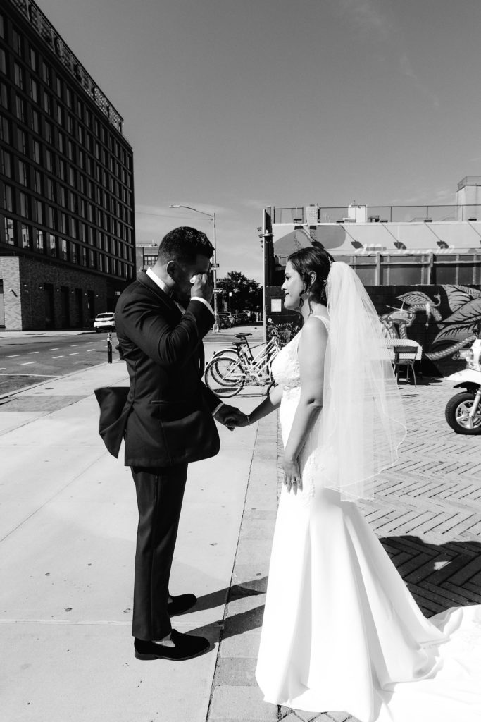 Newlyweds stand outside and share a private moment