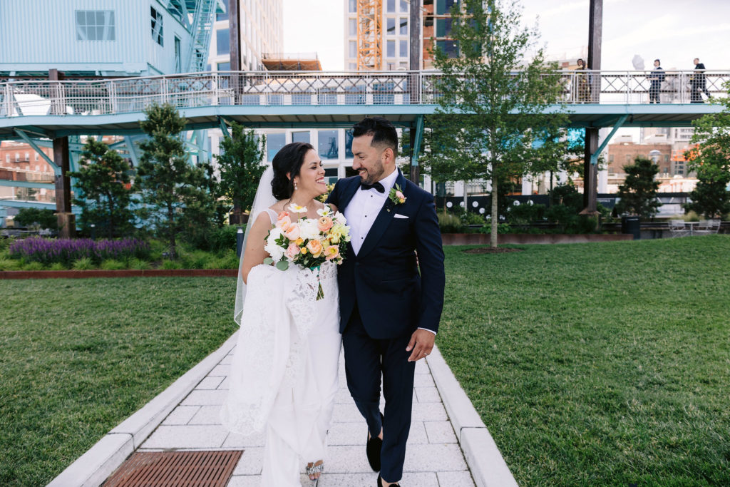 A bride and groom walk to their wedding ceremony