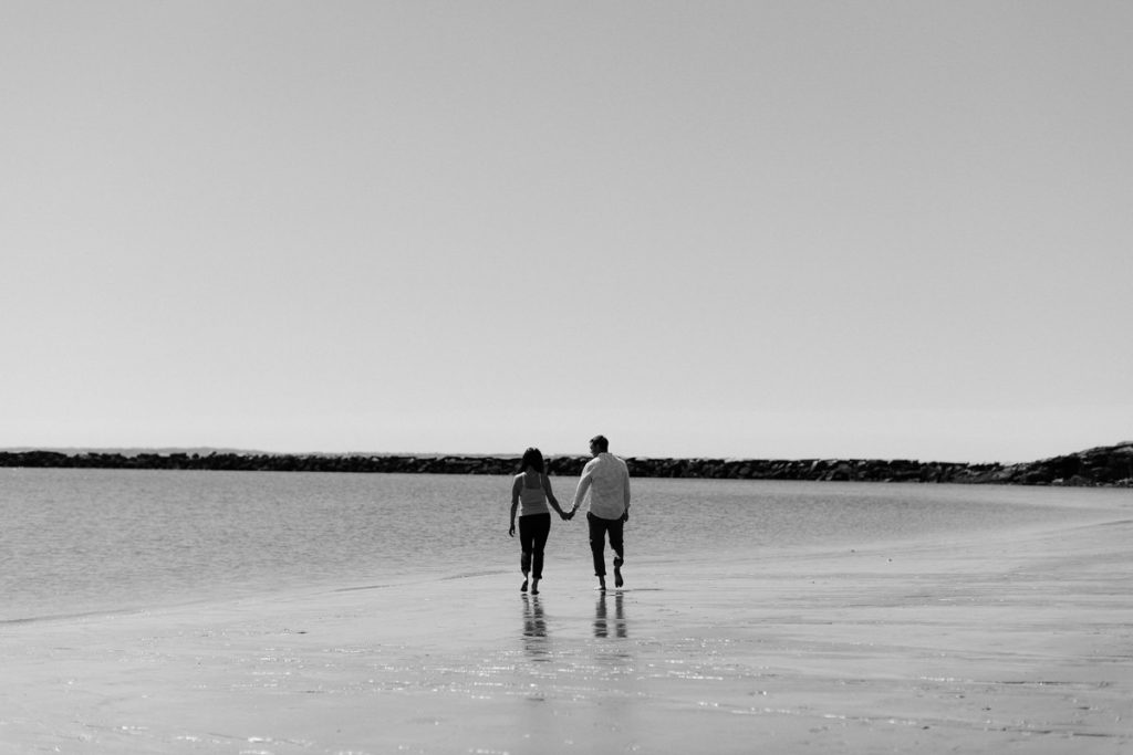 A couple holding hands for engagement photos