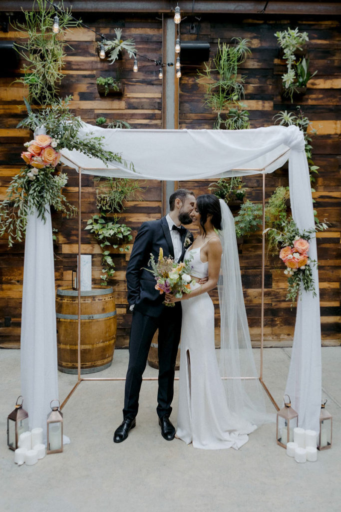 Bride and groom kissing at the Brooklyn Winery