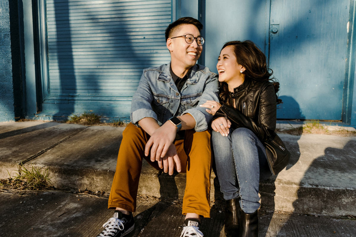 An engaged couple sits in the sun and remembers their engagement proposal