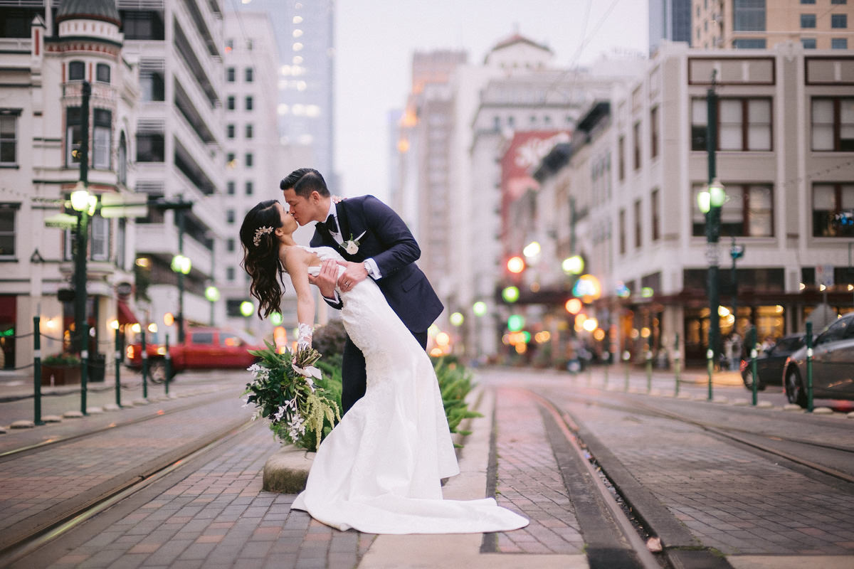 A groom dips his bride in a kiss on the streets on New York City