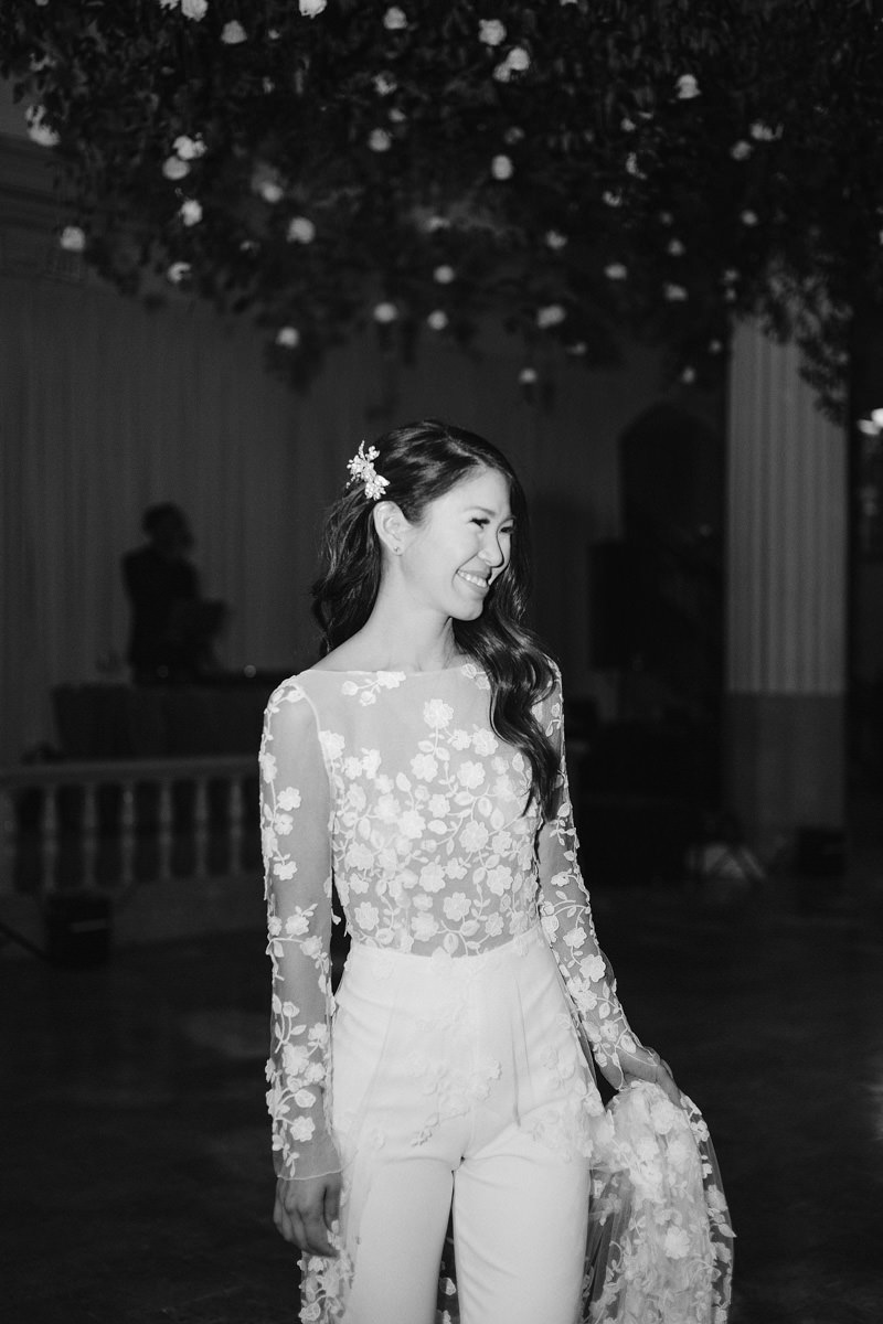 A bridal pantsuit with white flowers