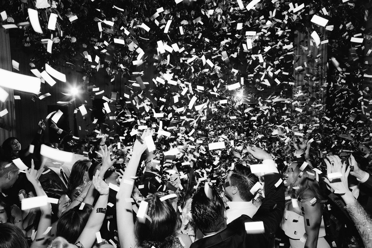 Confetti falls from the ceiling at a wedding reception