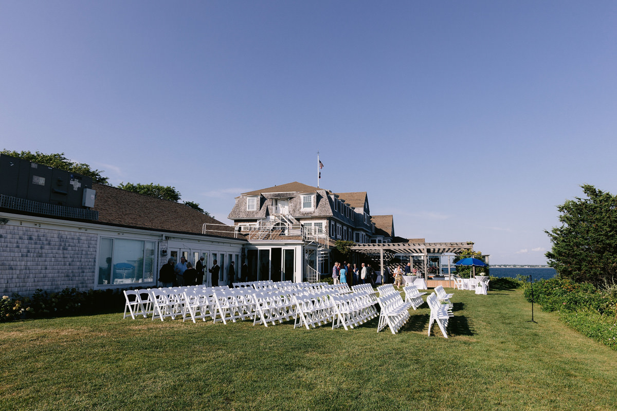 White chairs on a green lawn in the summer in Cape Cod.