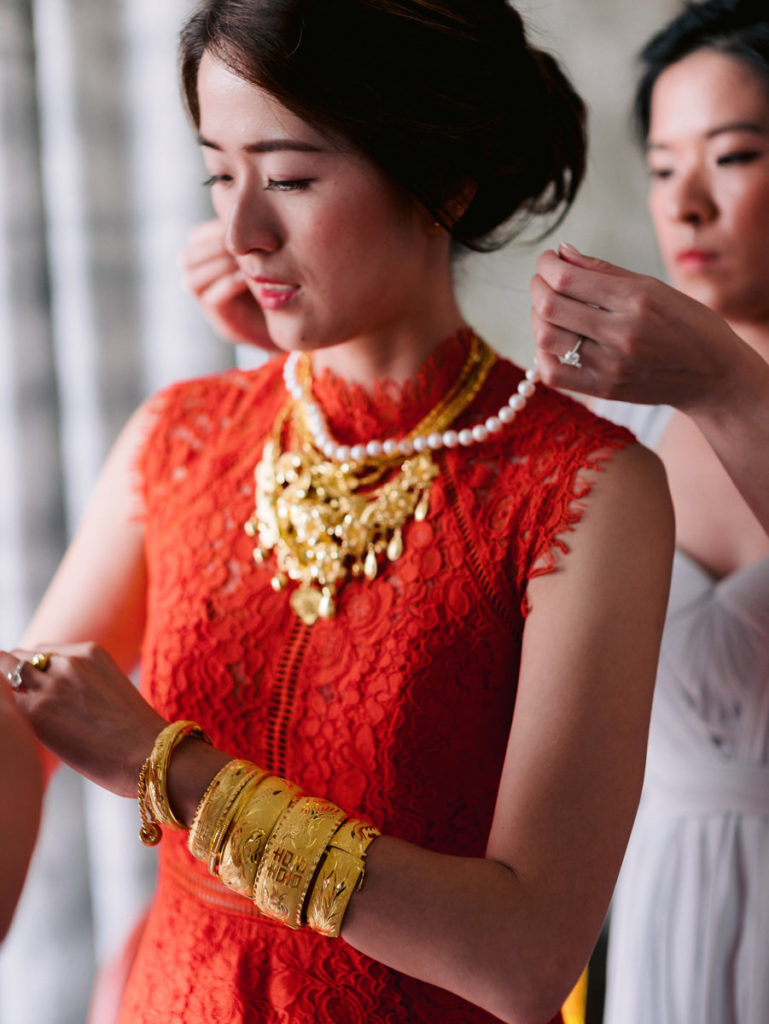 A bride in traditional Chinese red and gold on her wedding day