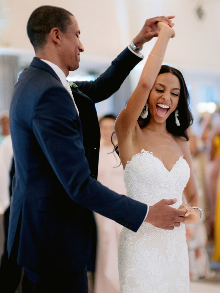 A groom spins his bride on the dance floor