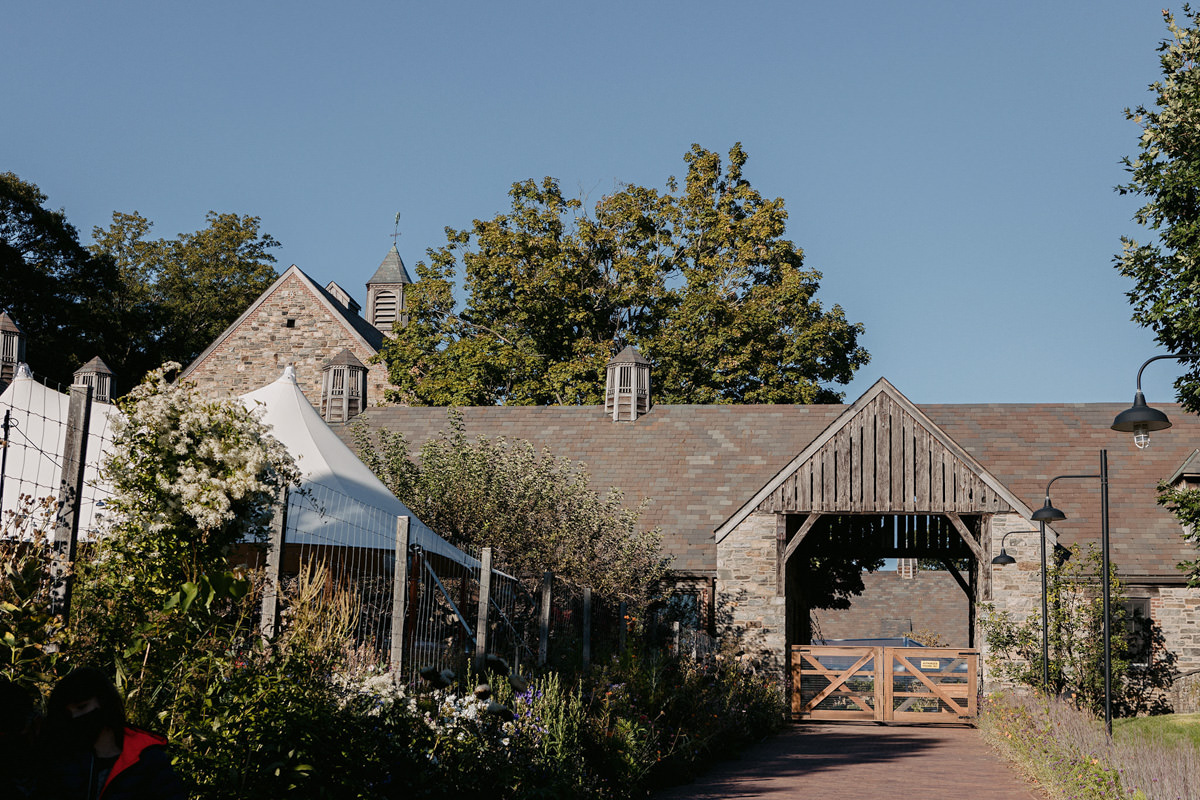 an old barnhouse) turned into a wedding reception) with flowers and plants in front and trees at the back